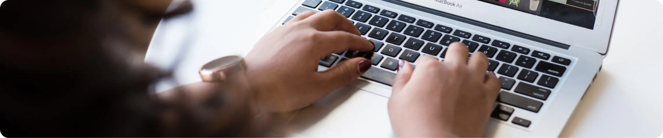 Hands typing on a computer